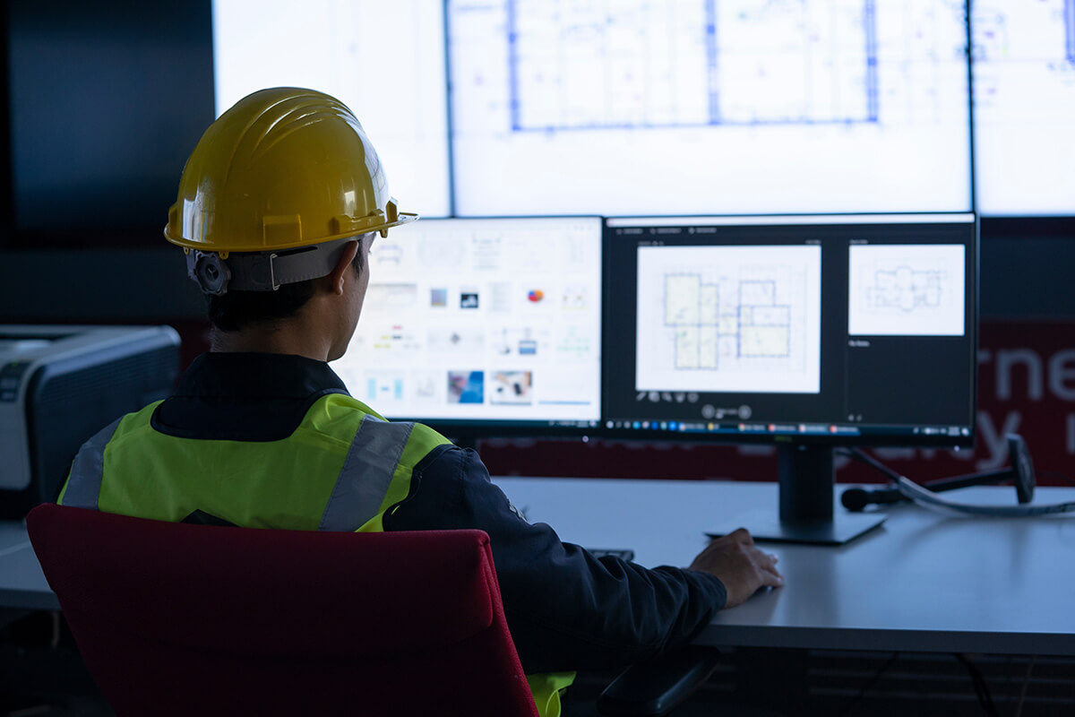 Industrial Engineering works in front of monitoring screen