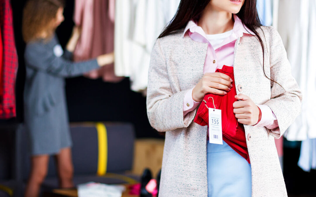 woman is stealing red jeans in store